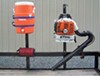 Pack'Em accessory holders on utility trailer holding water jog and leaf blower. 