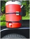 Rackem beverage cooler rack on open trailer holding red and white cooler.