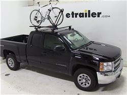 Roof mounted bicycle carrier on vehicle roof with bike installed