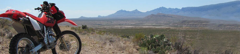 red dirtbike overlooking desert.