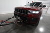 2024 jeep grand cherokee l tow bar base plate roadmaster twist lock attachment partially hidden on a vehicle