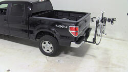 Thule hitch-mounted bicycle carrier installed on Ford F-150 truck with bike loaded