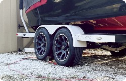 Boat trailer with black trailer tires.