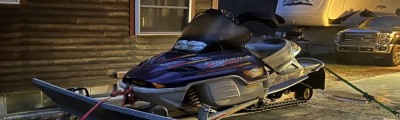 Purple snowmobile on trailer. 